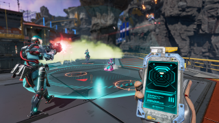 First-person perspective of a player holding a Node Tracker actively hacking while the battle rages on in front of them.