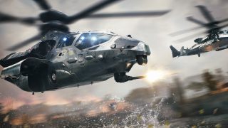 Two military helicopters flying over a body of water