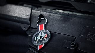 A weapon charm consisting of an "N7" medal with the text "Alliance Special Forces Training Program" circling it.