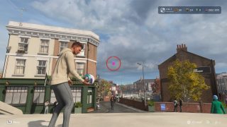 In-game screenshot from 'The Grounds' mode, showing a player in a casual street setting with a central targeting reticle on screen.