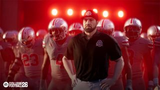 Ryan Day, heach coach of the Ohio State Buckeyes, stands with his players as they prepare to run onto the field.