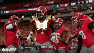 Georgia defensive players celebrate by putting gold, spiked shoulder pads onto one of it's players.