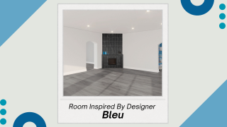 A white walled room with grey, wood flooring. The room is empty except for a fireplace in the corner. 