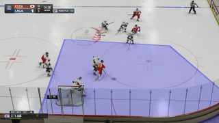 An in-game screenshot from an overhead perspective, showing a large blue-shaded area in front of the net to indicate defensive positioning.