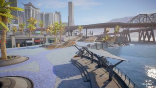 Waterfront skate park area, with tree planters and bridge in background. 
