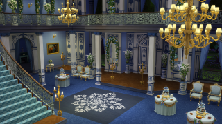 Ornate blue, white and gold ballroom with chandeliers, floral arches, banquet tables and grand staircase at night.