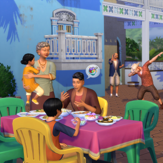 Ein lebendiges Familienessen: Sims sitzen draußen vor blau-weißen Gebäuden an einem Tisch und essen, während andere sich unterhalten oder tanzen.