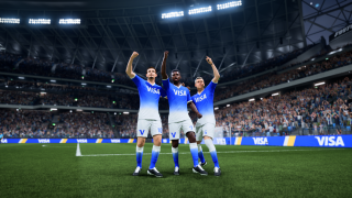 Three soccer players in blue “VISA” jerseys celebrate with raised arms on a stadium pitch, surrounded by a packed crowd and bright floodlights.